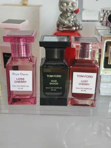 Comparaison visuelle entre un flacon de parfum de luxe à la cerise et une alternative de laboratoire de haute qualité.